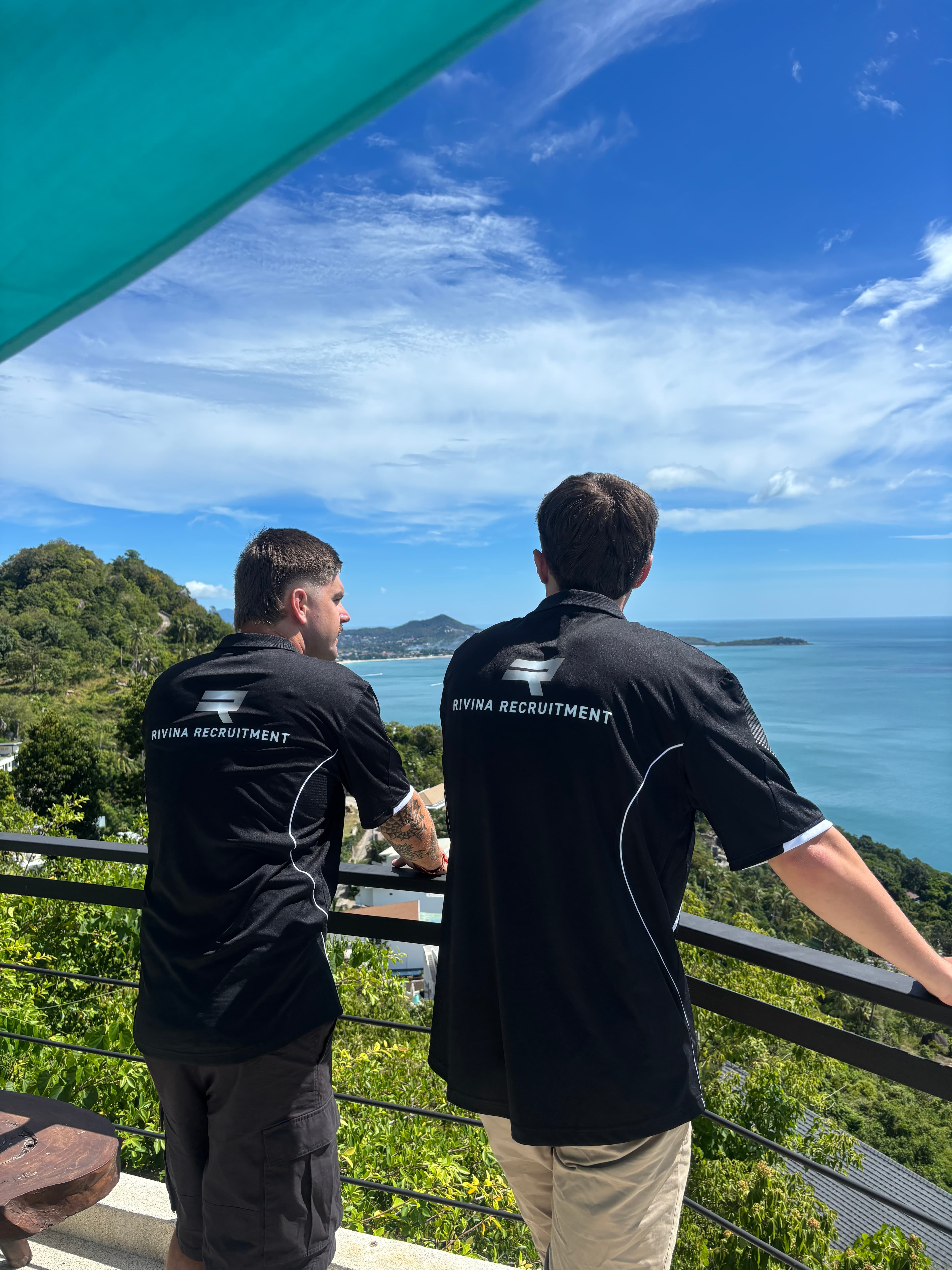 Rivina founders Flynn and Declan overlooking the coast in their Rivina Recruitment shirts